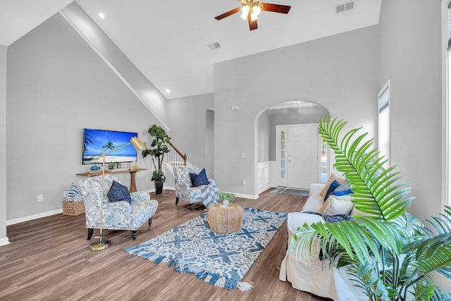 living room with wood-type flooring, high vaulted ceiling, and ceiling fan