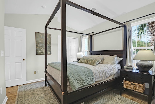 bedroom with hardwood / wood-style flooring and vaulted ceiling