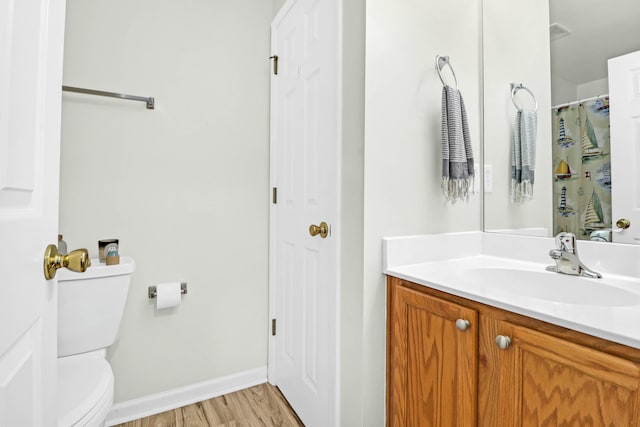 bathroom featuring hardwood / wood-style floors, vanity, and toilet