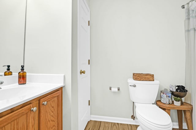 bathroom featuring hardwood / wood-style floors, vanity, and toilet