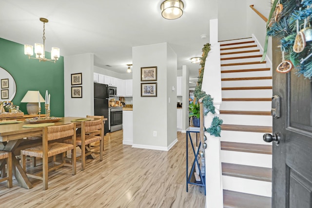 foyer featuring a chandelier and light hardwood / wood-style flooring