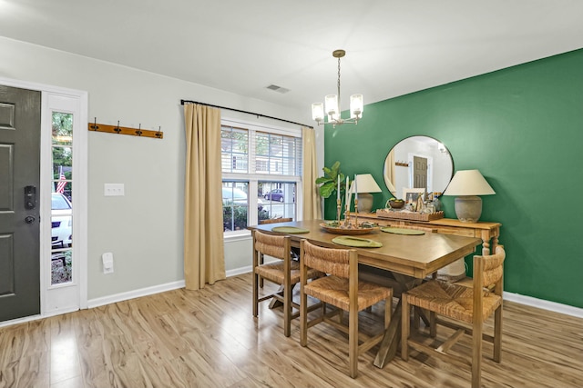 dining room featuring a chandelier and light wood-type flooring