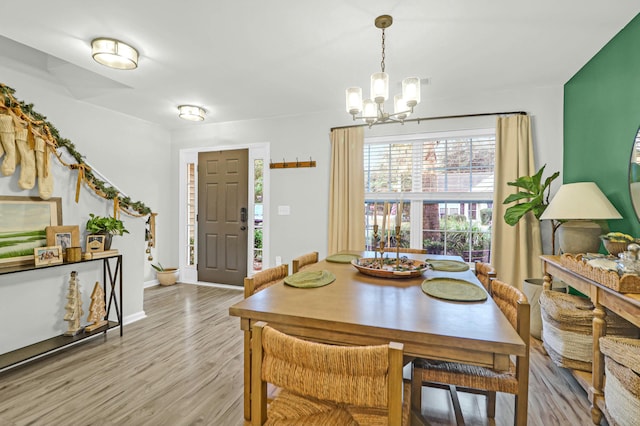 dining room featuring a notable chandelier and light hardwood / wood-style floors