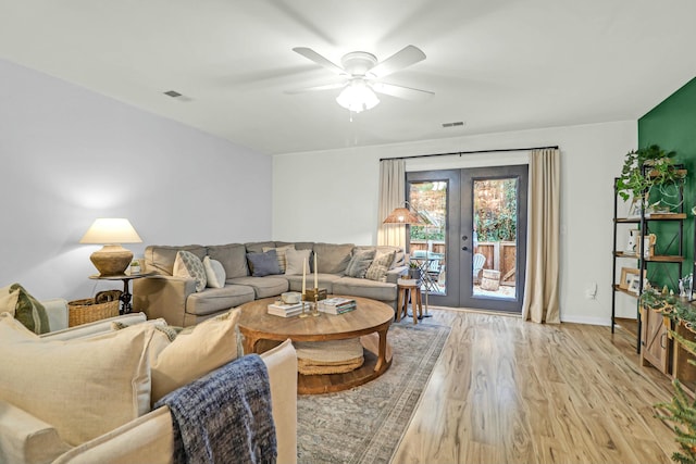 living room with ceiling fan, french doors, and light hardwood / wood-style flooring