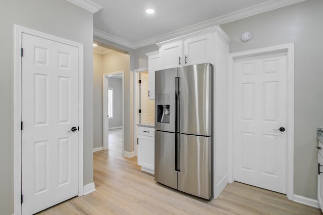 kitchen featuring ornamental molding, baseboards, white cabinets, stainless steel fridge with ice dispenser, and light wood-style flooring