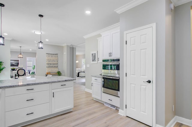 kitchen featuring double oven, recessed lighting, light wood-style flooring, and white cabinetry