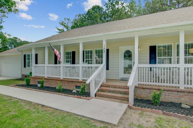 ranch-style house with a porch, a shingled roof, and an attached garage