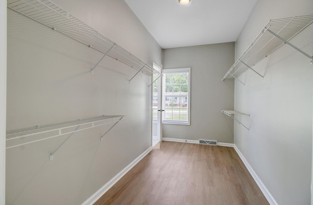 spacious closet with visible vents and wood finished floors