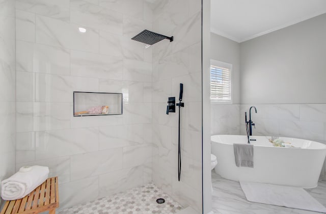 bathroom with crown molding, tile walls, a tile shower, marble finish floor, and a soaking tub
