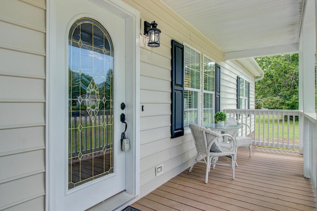 view of exterior entry featuring a porch and crawl space