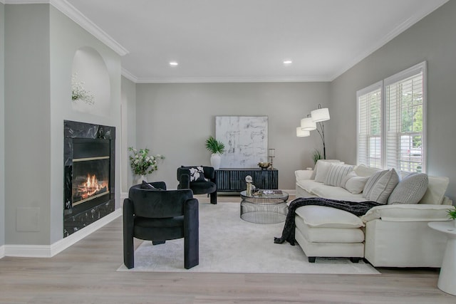 living area with a premium fireplace, recessed lighting, and wood finished floors