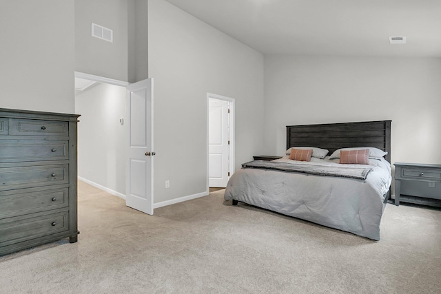 bedroom with baseboards, high vaulted ceiling, visible vents, and light colored carpet