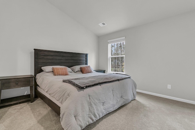 carpeted bedroom featuring visible vents, vaulted ceiling, and baseboards