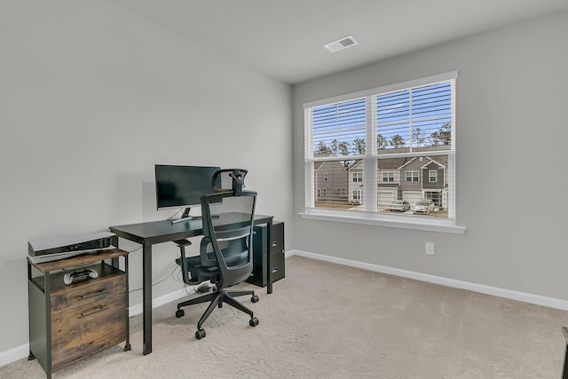 carpeted home office with visible vents and baseboards