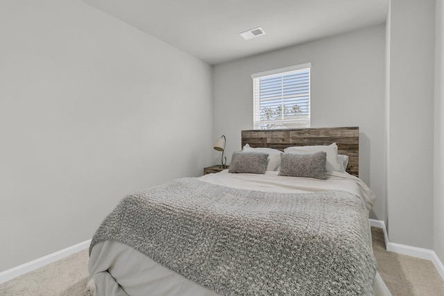 bedroom featuring carpet flooring, visible vents, and baseboards