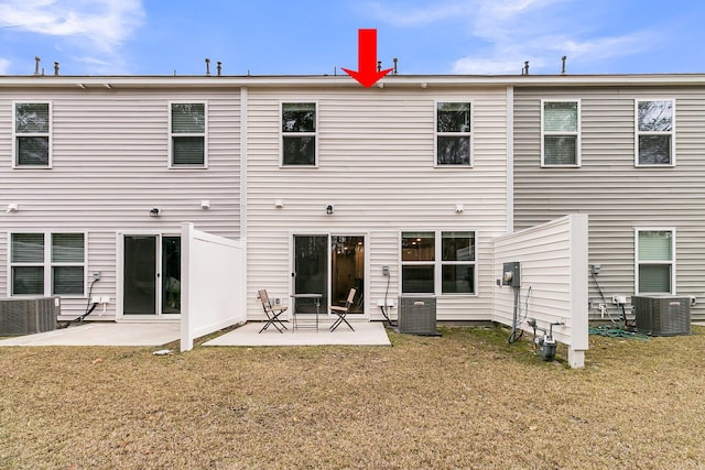 rear view of property with a lawn, central AC, and a patio