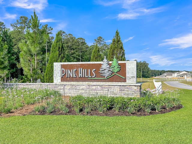 community / neighborhood sign featuring a lawn