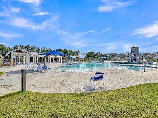 pool featuring a gazebo, a patio, and a lawn