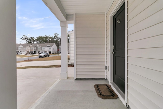 entrance to property with a residential view and covered porch