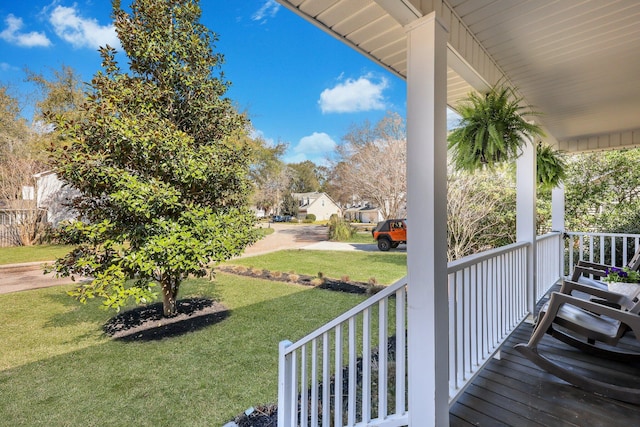 deck with a lawn and a porch