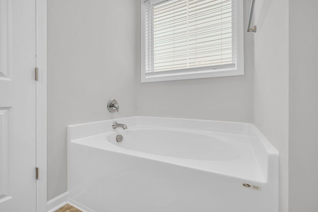 bathroom featuring a tub to relax in