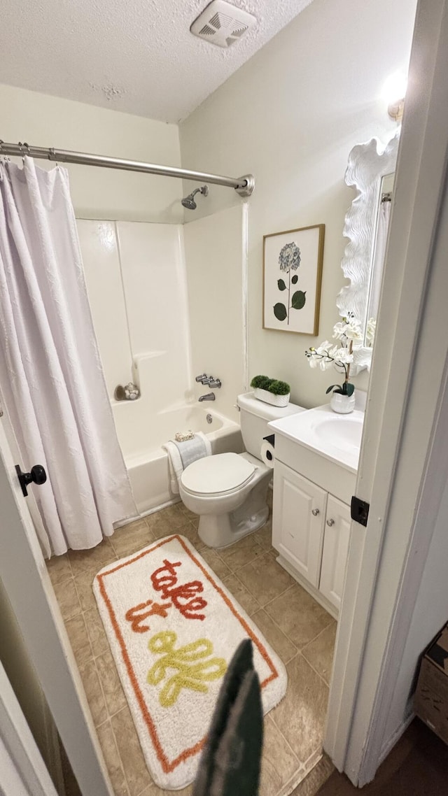 519 Parkdale Dr Unit J, Charleston, SC 29414 - full bath featuring a textured ceiling, tile patterned flooring, vanity, shower / bath combo with shower curtain, and toilet