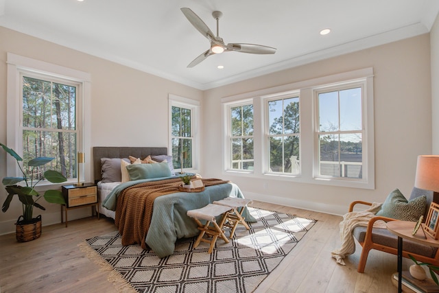 bedroom with ceiling fan, light hardwood / wood-style flooring, and crown molding