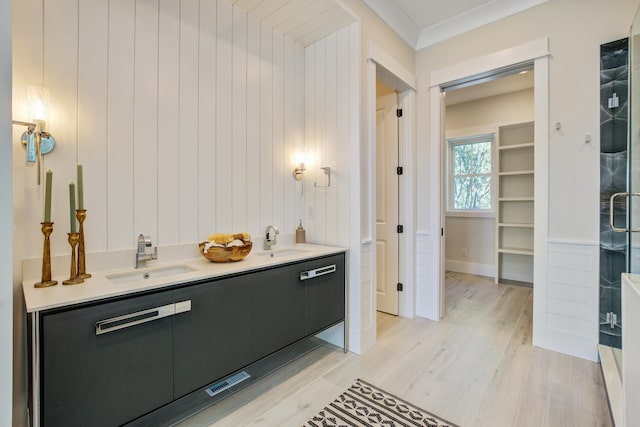 bathroom with ornamental molding, vanity, walk in shower, and wood-type flooring