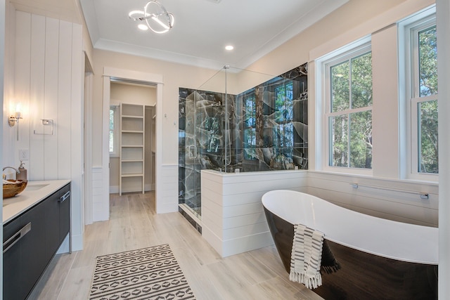 bathroom with shower with separate bathtub, a wealth of natural light, vanity, and ornamental molding