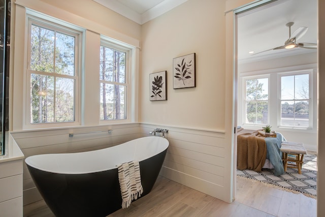 bathroom with hardwood / wood-style floors, a healthy amount of sunlight, and a bathtub