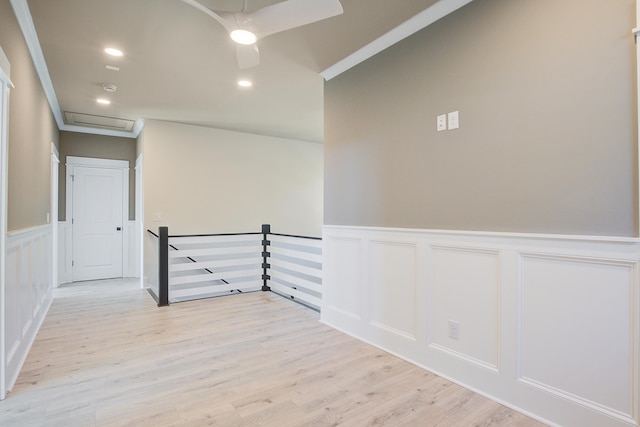 spare room with light wood-type flooring and crown molding