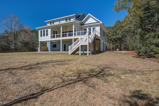 rear view of property with a yard and ceiling fan