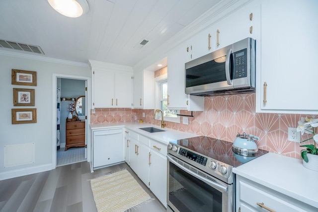 kitchen featuring white cabinets, sink, stainless steel appliances, and tasteful backsplash