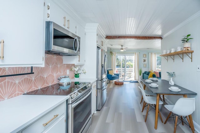 kitchen featuring white cabinets, ceiling fan, backsplash, and appliances with stainless steel finishes