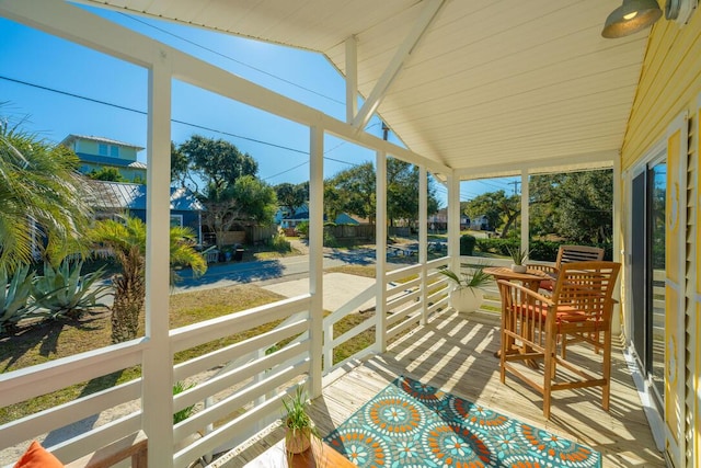 sunroom featuring lofted ceiling