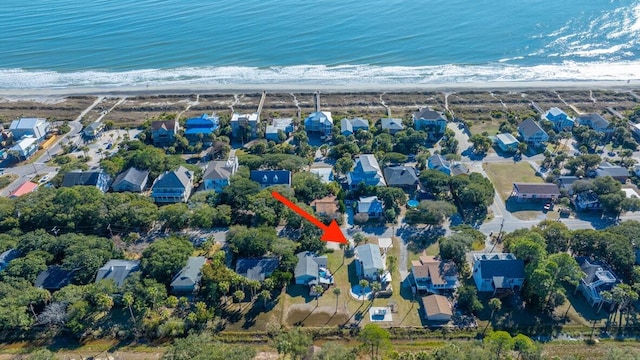 drone / aerial view with a water view and a beach view