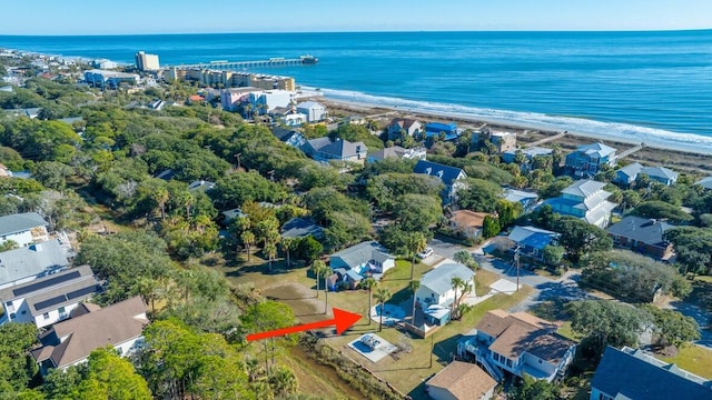 drone / aerial view featuring a beach view and a water view