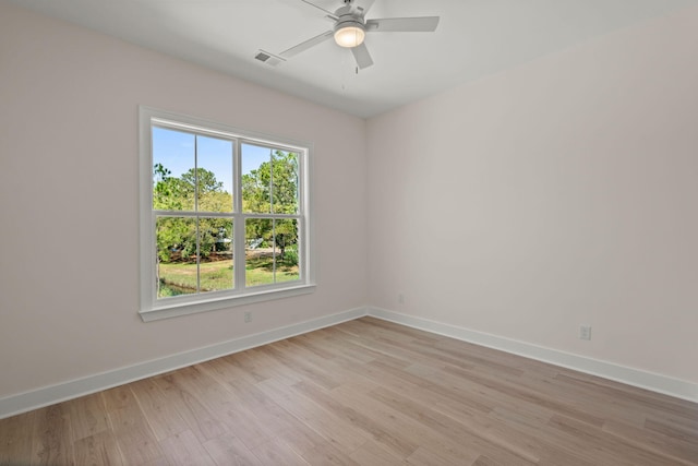 unfurnished room with baseboards, visible vents, light wood-style floors, and ceiling fan