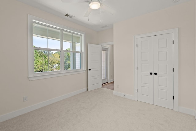 unfurnished bedroom with carpet floors, baseboards, a closet, and visible vents
