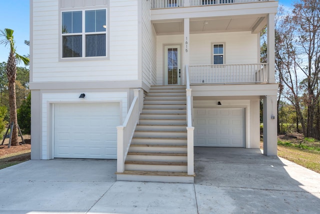 view of front of house featuring stairs, driveway, and a garage