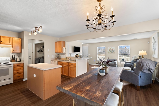 kitchen with separate washer and dryer, a center island, a textured ceiling, dark hardwood / wood-style flooring, and white electric stove