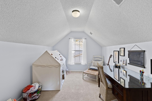 interior space featuring vaulted ceiling, light colored carpet, and a textured ceiling