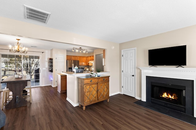 kitchen featuring hanging light fixtures, dark hardwood / wood-style floors, a chandelier, and stainless steel refrigerator with ice dispenser