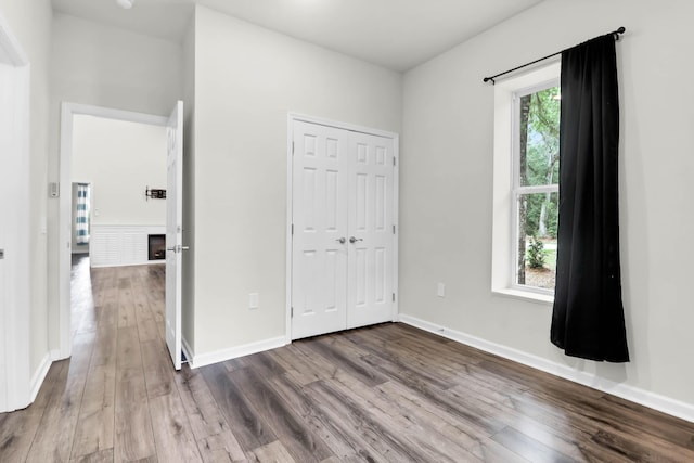 5233 Maybank Hwy, Wadmalaw Island, SC 29487 - unfurnished bedroom with dark wood finished floors, a closet, and baseboards