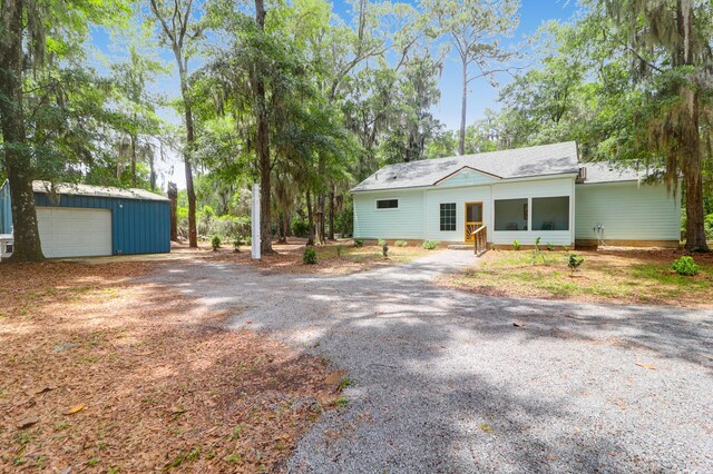 5233 Maybank Hwy, Wadmalaw Island, SC 29487 - ranch-style home featuring gravel driveway, an outbuilding, and entry steps