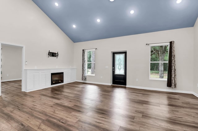 5233 Maybank Hwy, Wadmalaw Island, SC 29487 - unfurnished living room with a fireplace, high vaulted ceiling, dark wood-style flooring, baseboards, and recessed lighting