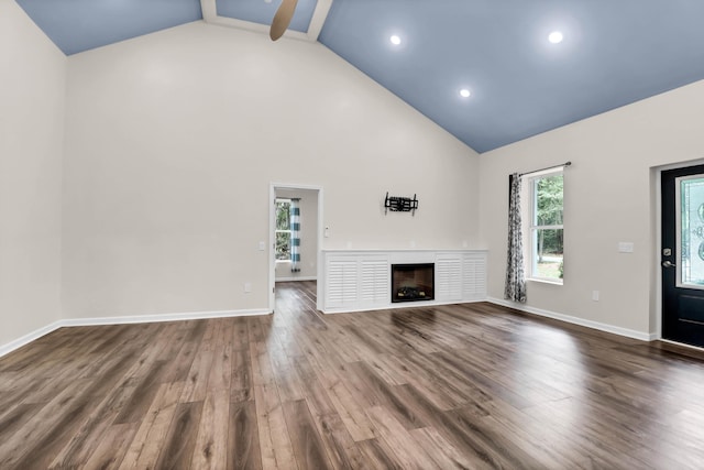 5233 Maybank Hwy, Wadmalaw Island, SC 29487 - unfurnished living room featuring high vaulted ceiling, a fireplace, dark wood finished floors, baseboards, and recessed lighting