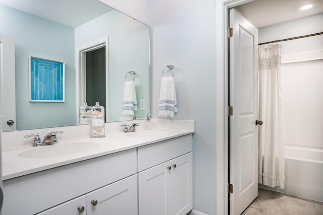 bathroom with double vanity, a sink, and shower / bathtub combination with curtain