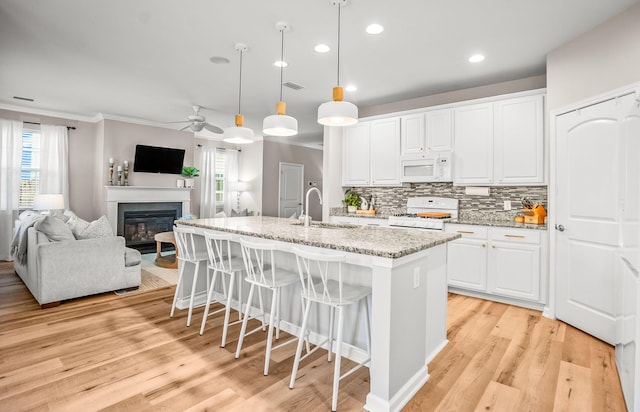 153 Glory Rd, Beaufort, SC 29906 - kitchen featuring white microwave, range, a ceiling fan, healthy amount of natural light, and ornamental molding