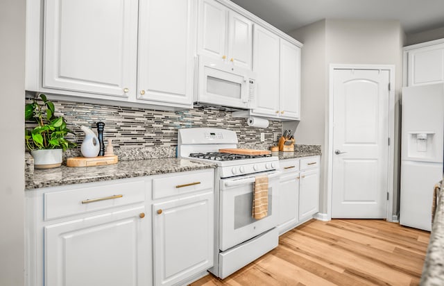 153 Glory Rd, Beaufort, SC 29906 - kitchen with white appliances, tasteful backsplash, white cabinets, light wood-style floors, and light stone countertops